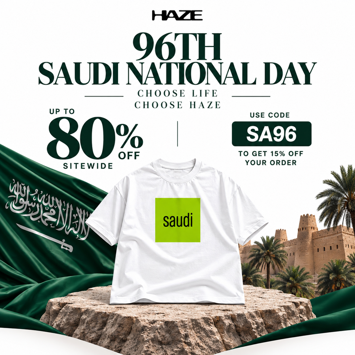 A white short-sleeve crewneck t-shirt with 'SAUDI #SWAG' printed on the front in a green camouflage pattern, shown against a plain white background.