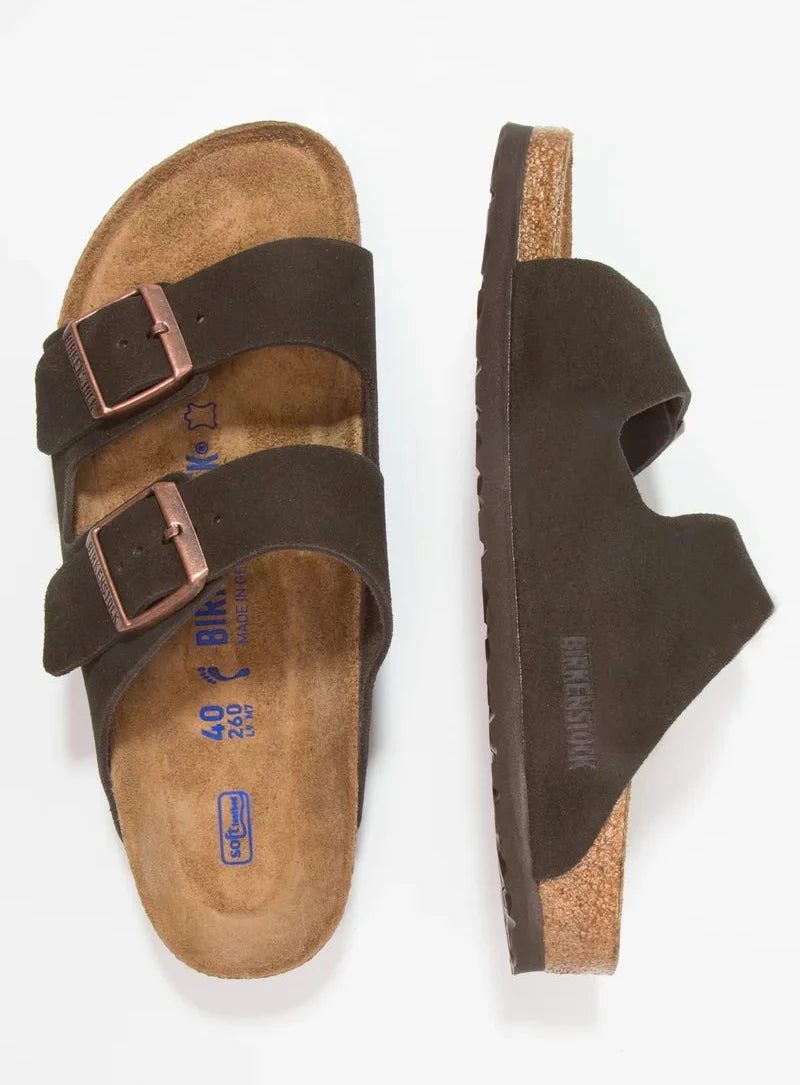 Brown suede sandal with cork sole on a white background
