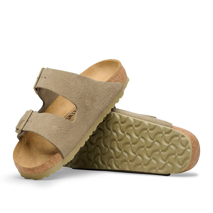 Pair of beige sandals on a white background