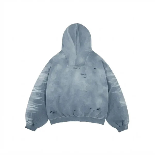 A light blue-gray distressed hoodie with a tie-dye or watercolor-like pattern, featuring small dark distressed marks on the front, shown against a plain white background.