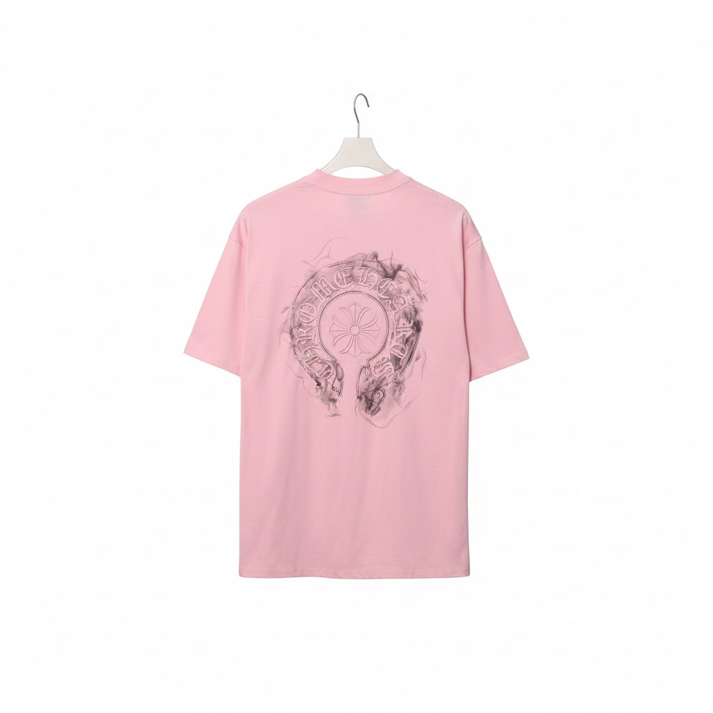 Pink t-shirt with graphic design on a rack against a gray background