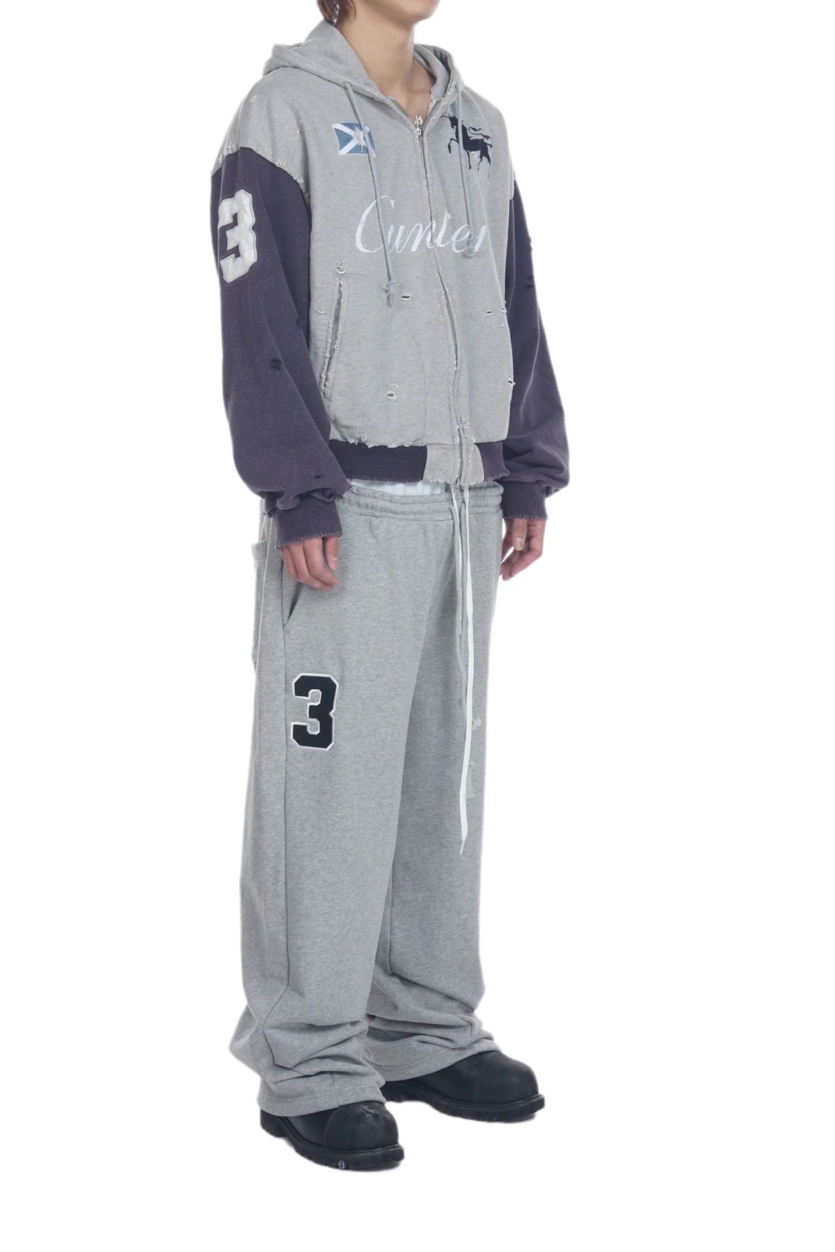 A model wearing a gray and navy color-blocked zip-up hoodie with 'Cunlee' embroidered on the chest, paired with matching gray sweatpants featuring a black number 3 on the leg.
