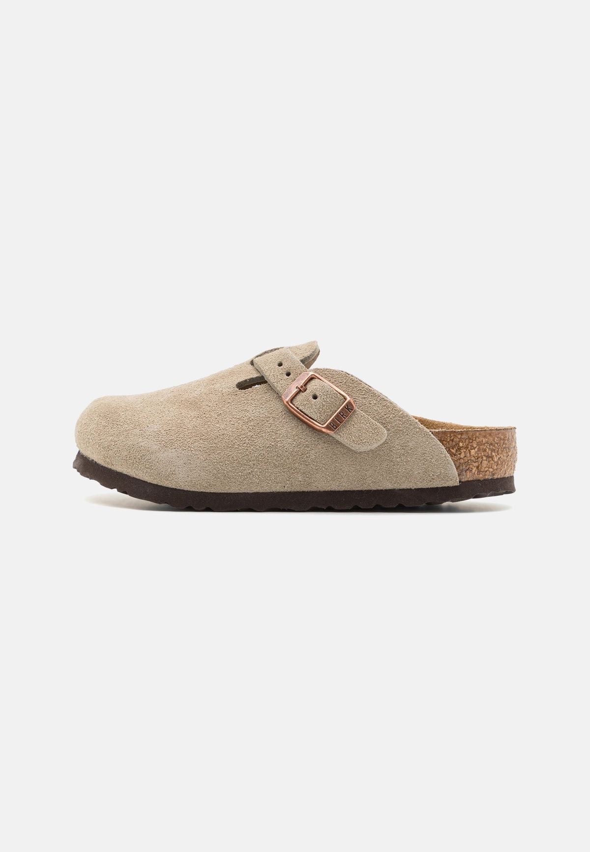 Beige suede clog shoe with a brown buckle on a white background