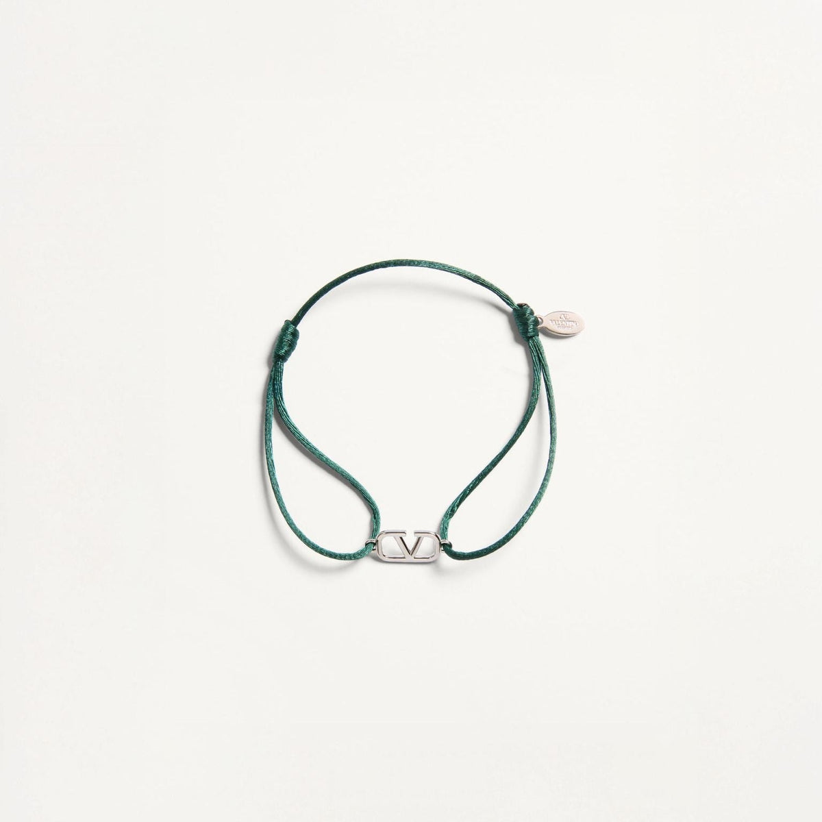 Green bracelet with a silver clasp on a white background