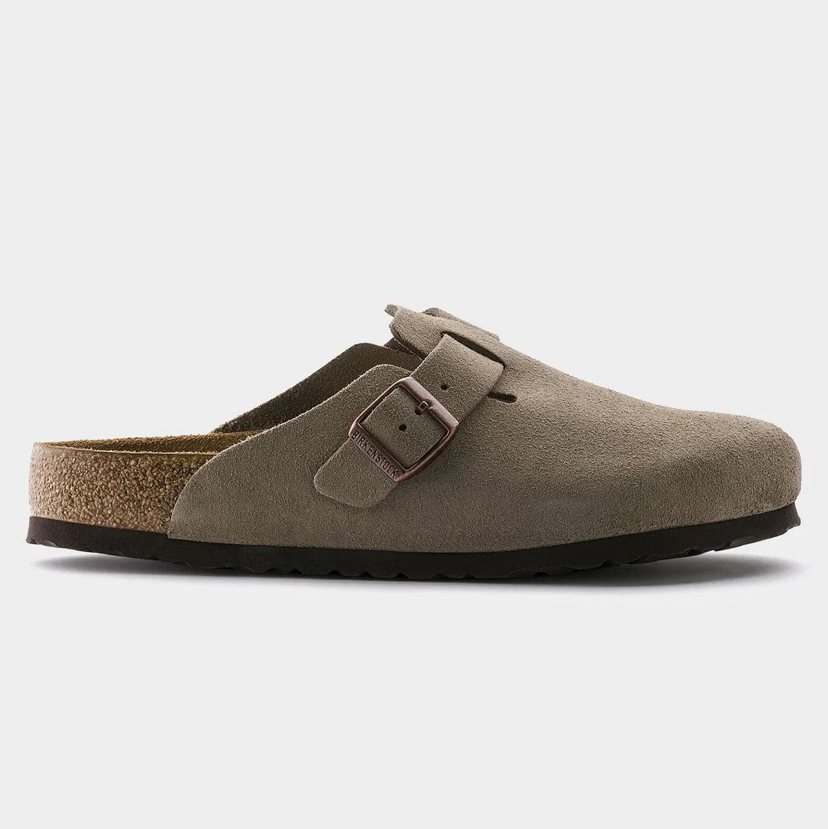 Beige sandal with a single buckle on a light gray background
