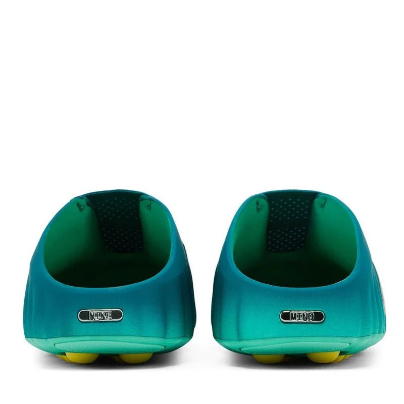 Pair of teal shoes with yellow sole on a white background