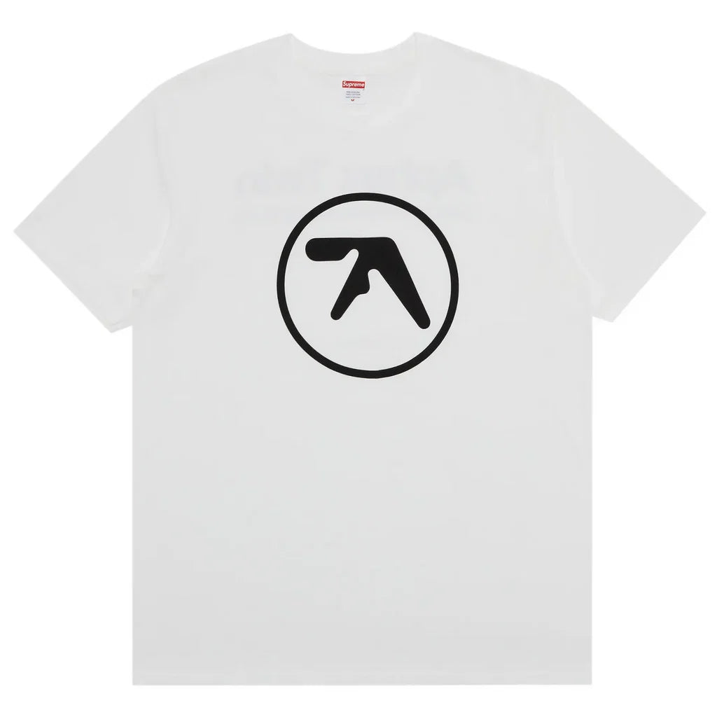 A white short-sleeve crewneck t-shirt featuring a black circular logo with a stylized letter 'A' on the chest, displayed against a solid white background.