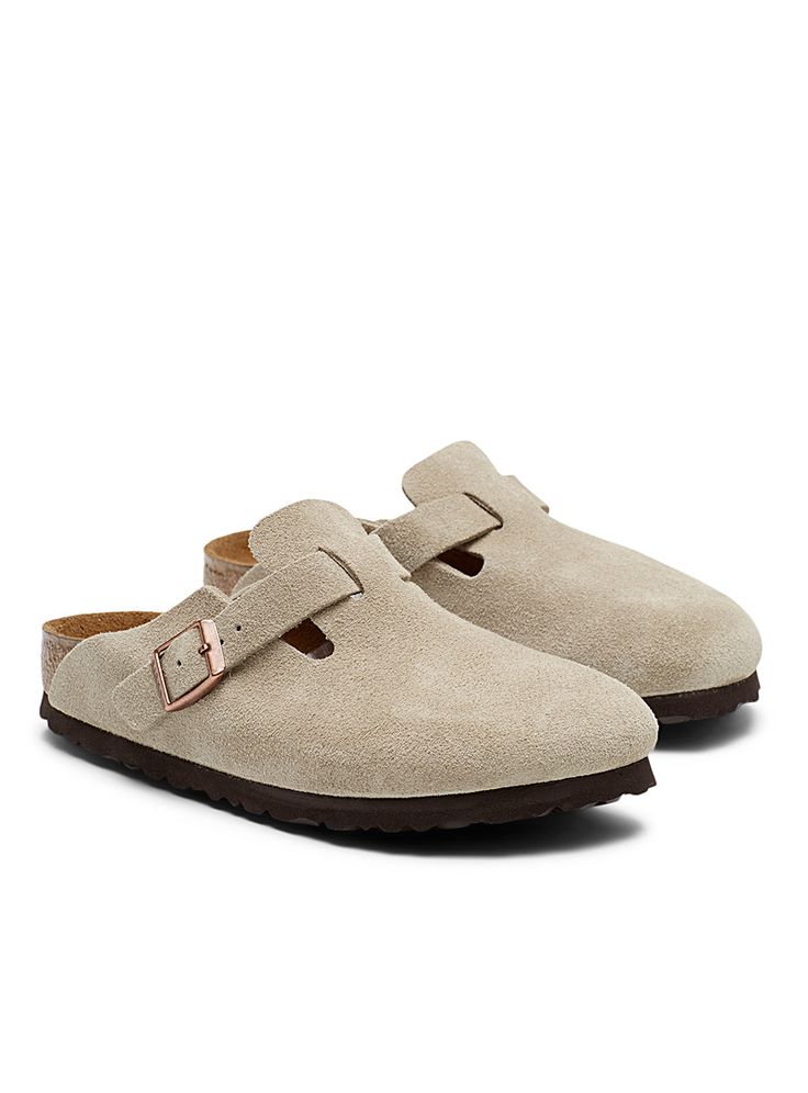 Pair of beige suede shoes with brown soles on a white background