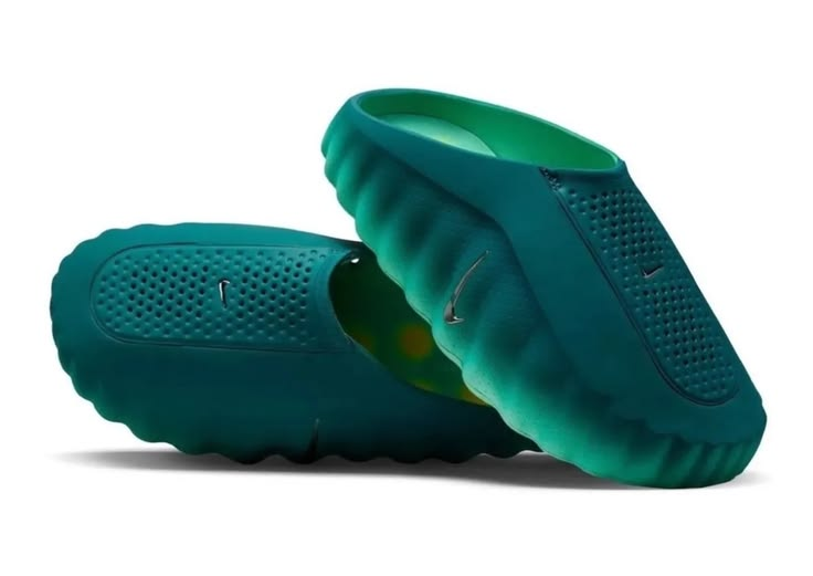 Teal baby shoes with Nike logo on a white background