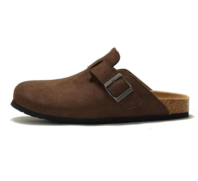 Brown suede clog shoe with a buckle on a white background