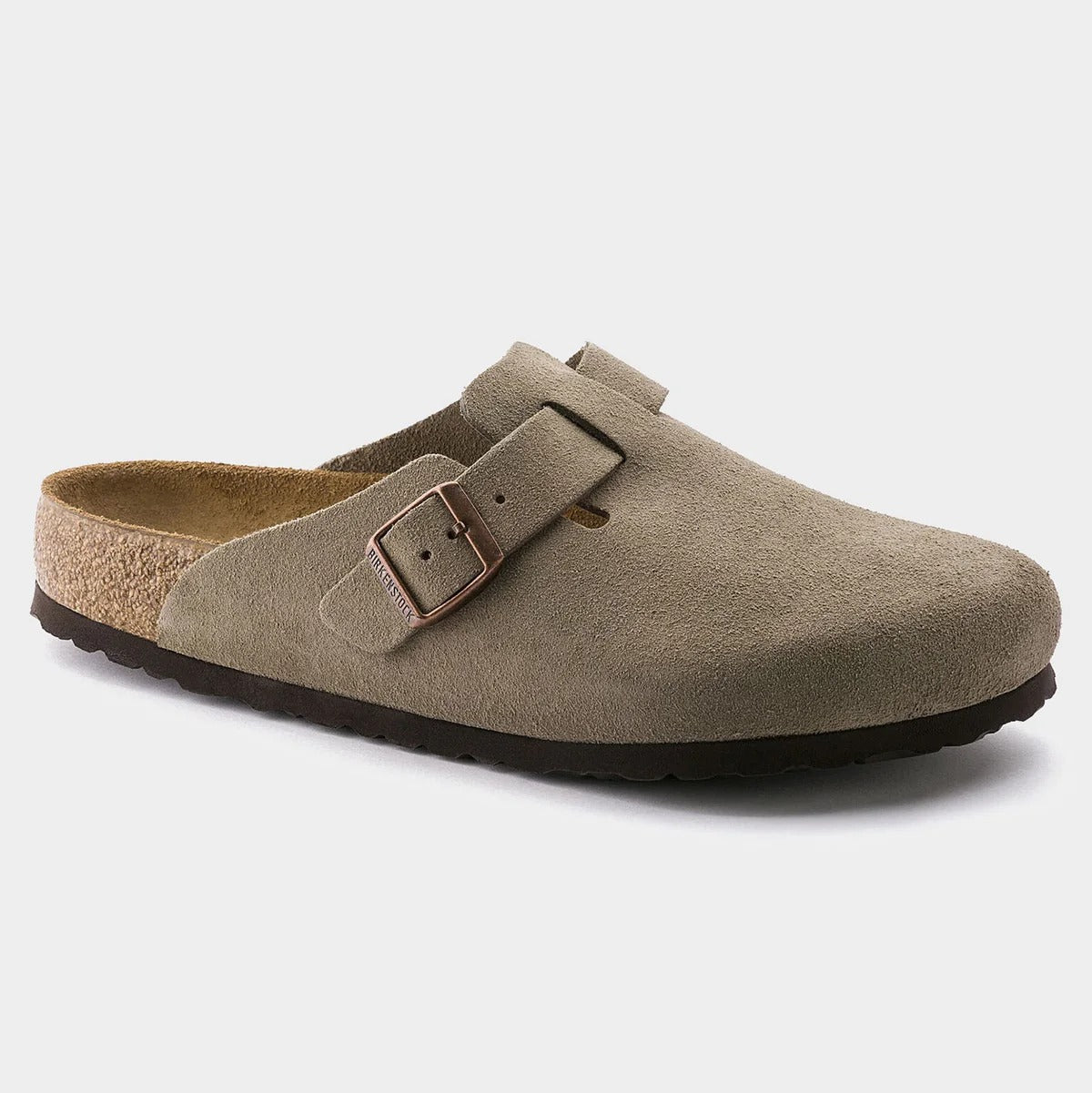 Brown suede clog shoe with a buckle on a light gray background