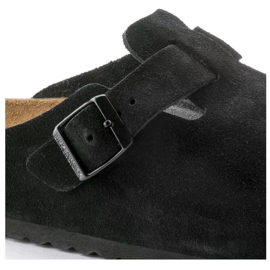 Black suede shoe with a buckle on a white background